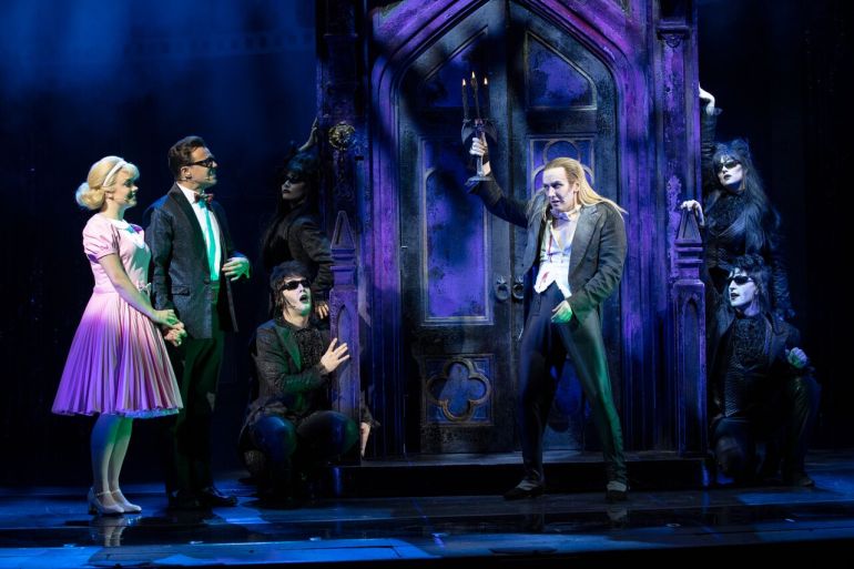 Riff Raff and phantoms greet Brad and Janet