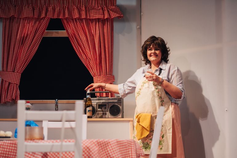 Shirley in kitchen with radio